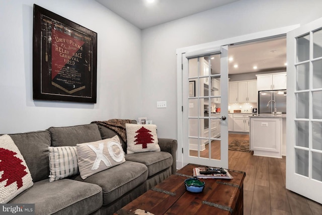 living room with french doors and dark wood-type flooring