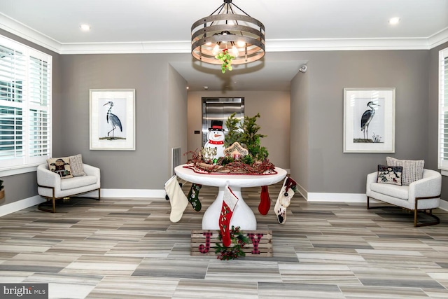 dining area featuring light hardwood / wood-style floors, ornamental molding, and a chandelier