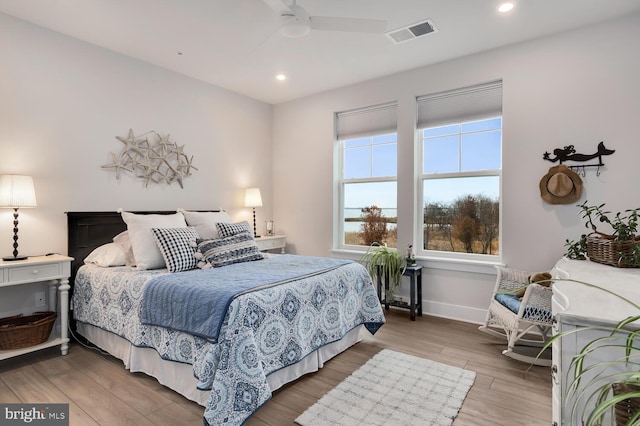 bedroom with hardwood / wood-style floors and ceiling fan