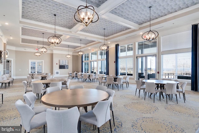 dining area with beamed ceiling, plenty of natural light, a towering ceiling, and coffered ceiling