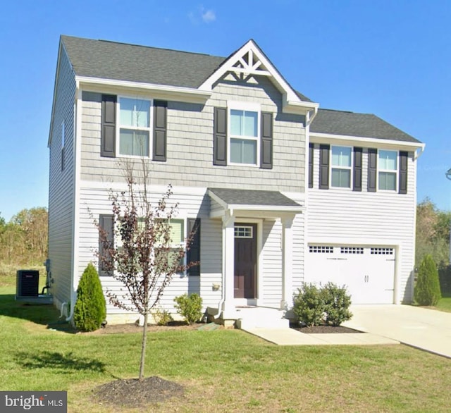 view of front of home with a garage and a front lawn