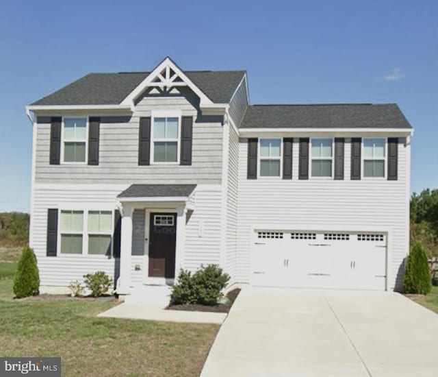 view of front of house featuring a front yard and a garage