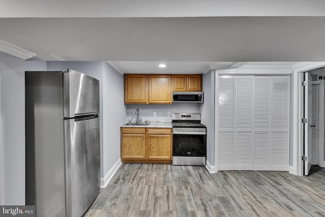 kitchen featuring sink, light hardwood / wood-style floors, and appliances with stainless steel finishes