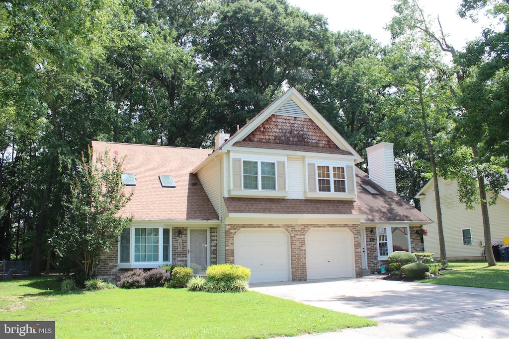 view of front of home featuring a garage and a front lawn