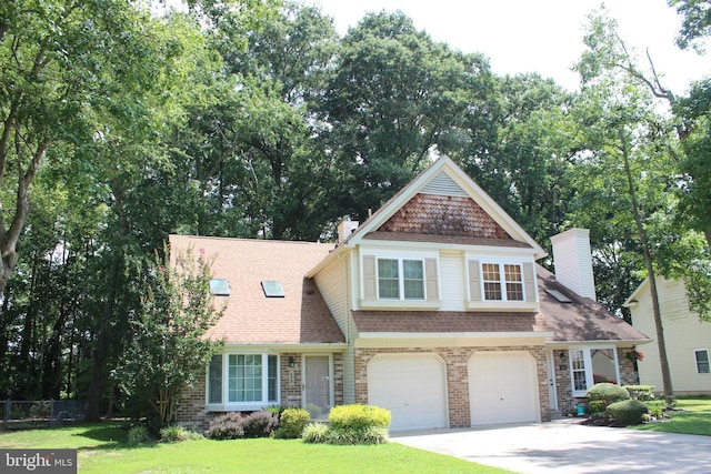 view of front of house with a front yard and a garage