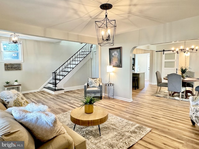 living room with a barn door and hardwood / wood-style floors