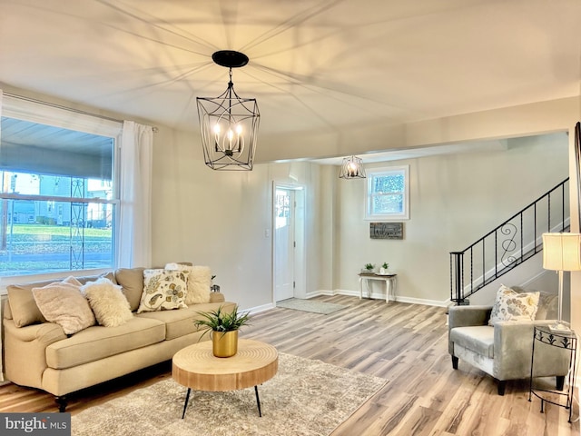 living room featuring hardwood / wood-style floors and a notable chandelier