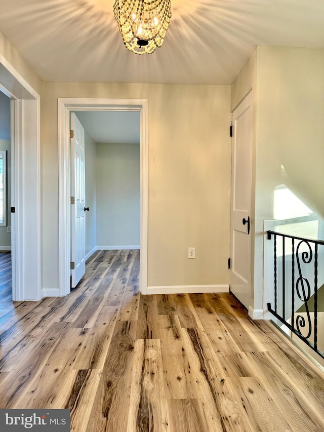 interior space featuring hardwood / wood-style flooring and an inviting chandelier