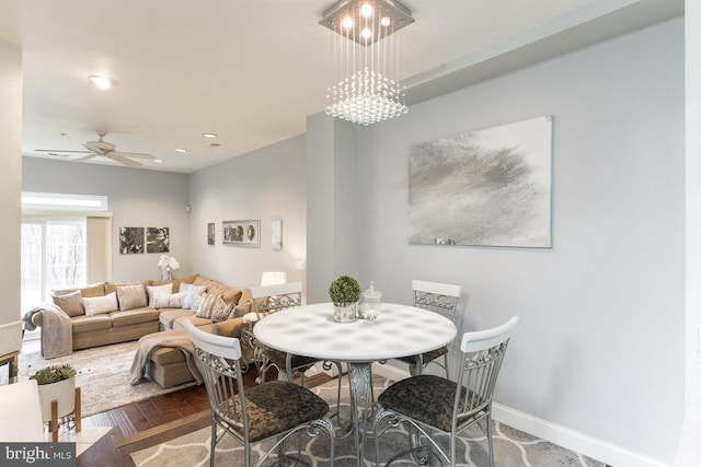 dining area with ceiling fan and hardwood / wood-style floors