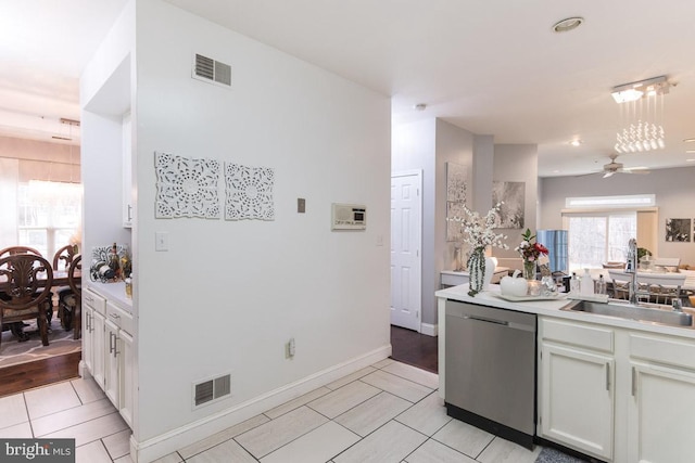 kitchen featuring dishwasher, white cabinets, sink, light hardwood / wood-style flooring, and ceiling fan