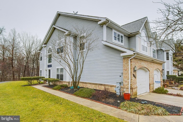 view of property exterior with a garage and a lawn