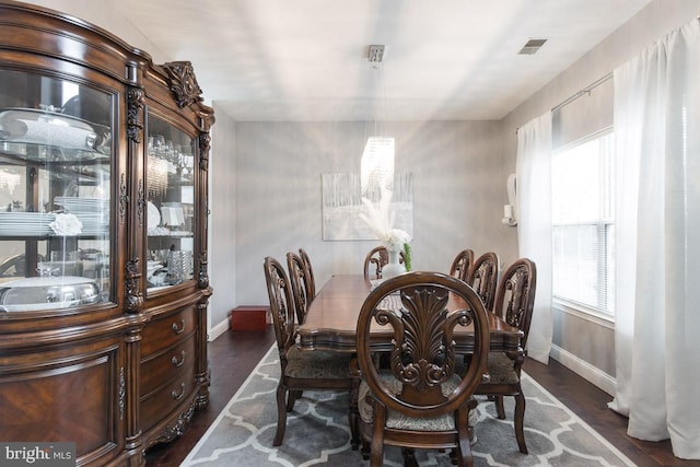 dining space with dark hardwood / wood-style flooring