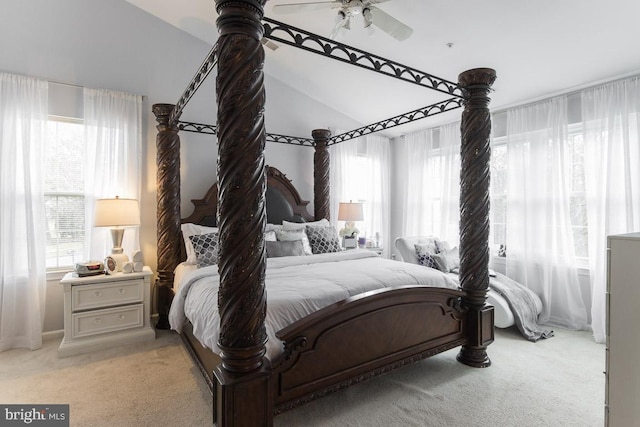 bedroom featuring ceiling fan, lofted ceiling, and light carpet