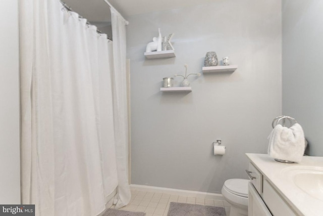 bathroom with tile patterned flooring, vanity, and toilet