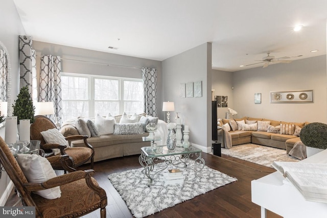 living room with ceiling fan and dark wood-type flooring