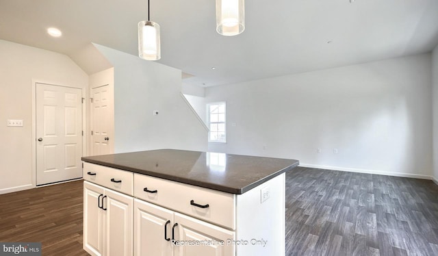 kitchen with decorative light fixtures, a center island, dark hardwood / wood-style flooring, and white cabinetry