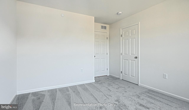 unfurnished room with light carpet