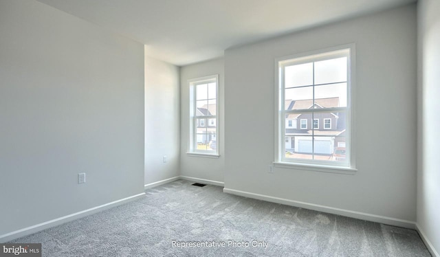 unfurnished room featuring carpet