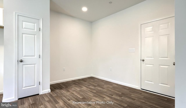 unfurnished room with dark hardwood / wood-style floors