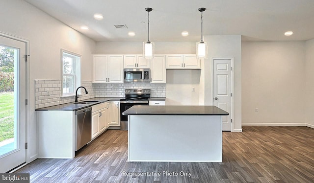 kitchen featuring sink, white cabinetry, stainless steel appliances, and a wealth of natural light