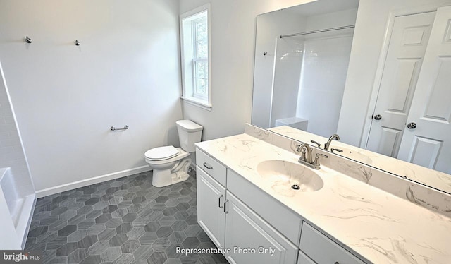 bathroom with a shower, vanity, and toilet