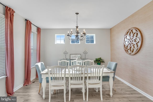 dining room featuring a notable chandelier and light hardwood / wood-style floors