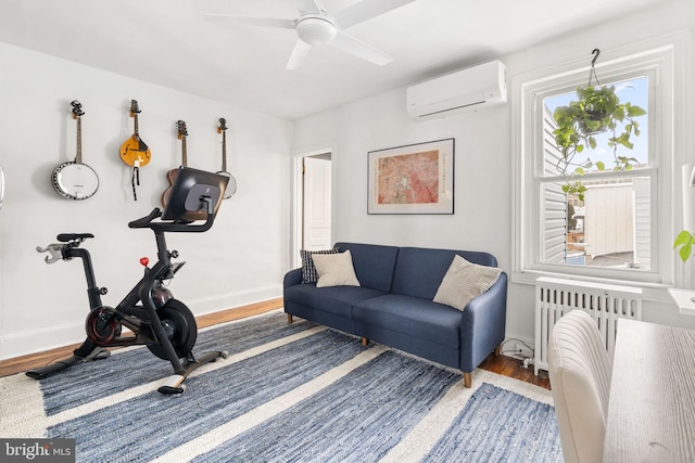 workout room featuring hardwood / wood-style flooring, ceiling fan, a wall mounted air conditioner, and radiator