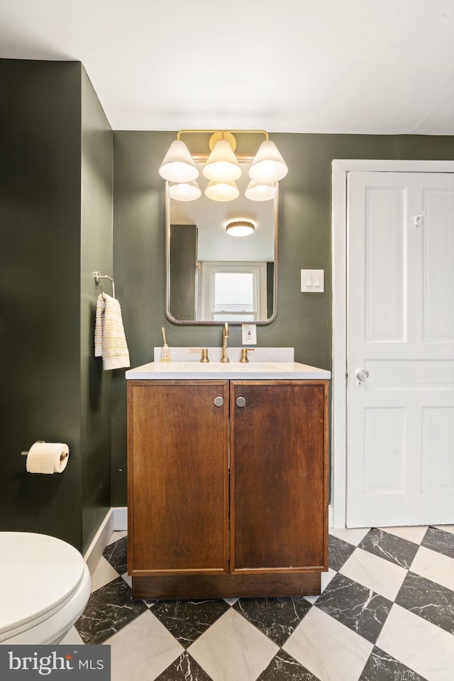 bathroom featuring vanity and toilet