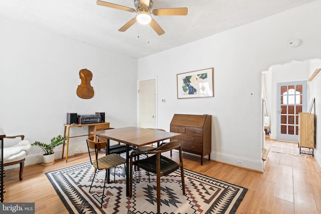 dining space with light hardwood / wood-style flooring and ceiling fan