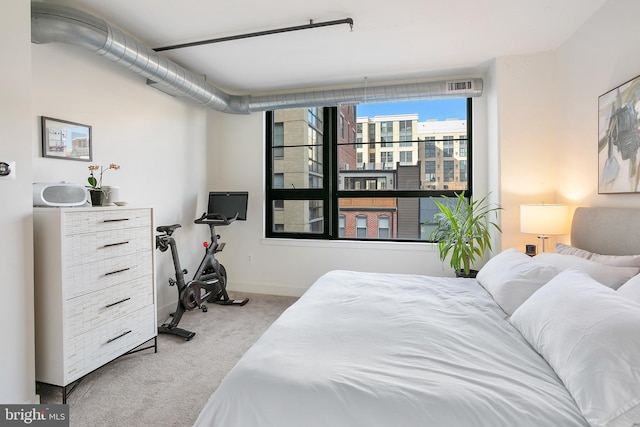 carpeted bedroom featuring baseboards