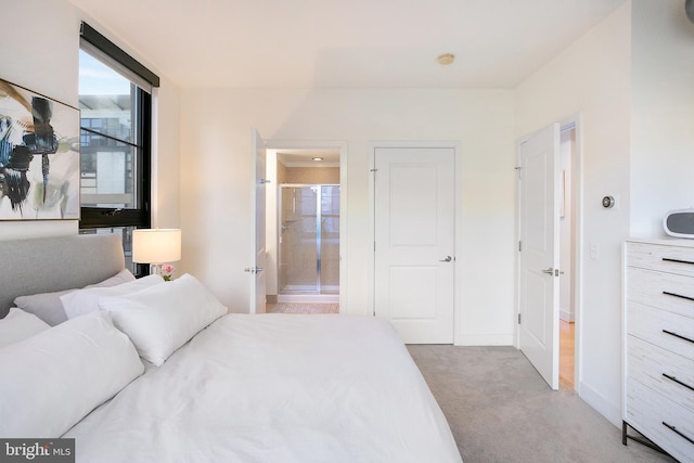 bedroom with carpet flooring, connected bathroom, and baseboards