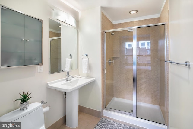 full bathroom with baseboards, a stall shower, toilet, and tile patterned floors