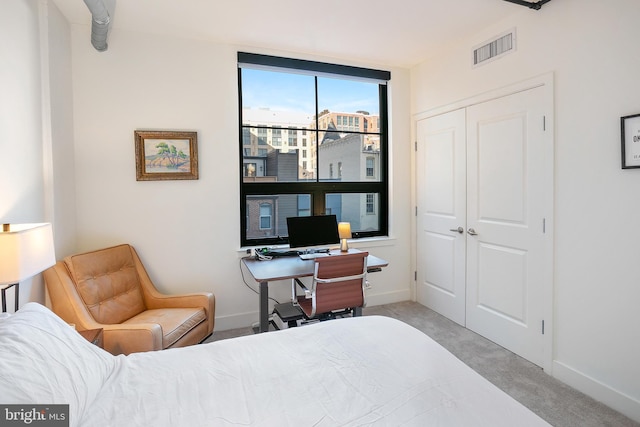 bedroom featuring carpet, a closet, visible vents, and baseboards