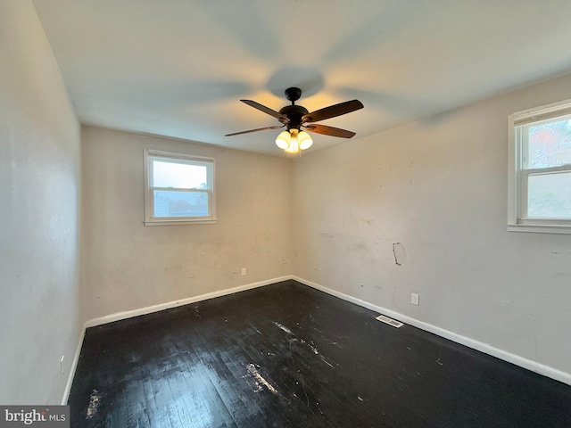 spare room featuring hardwood / wood-style flooring and ceiling fan