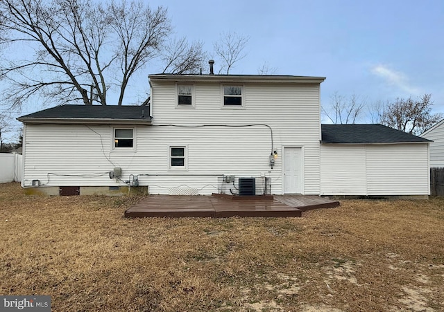 rear view of property featuring central air condition unit, a yard, and a wooden deck