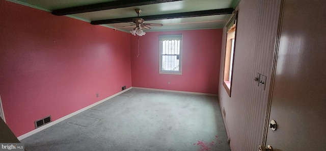 empty room featuring carpet flooring, ceiling fan, and beam ceiling