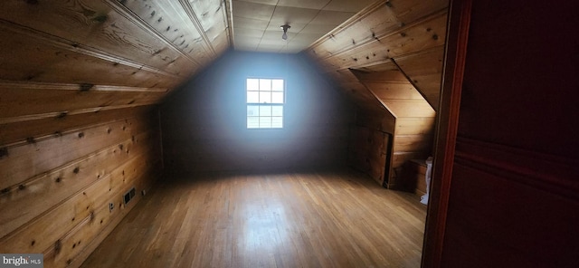 additional living space with wood ceiling, lofted ceiling, wooden walls, and light hardwood / wood-style flooring