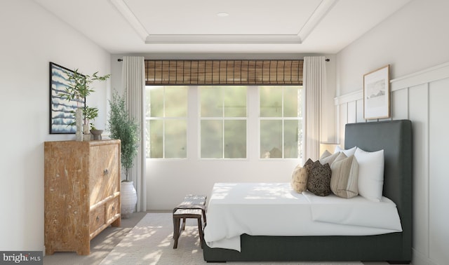 bedroom with carpet flooring and a tray ceiling