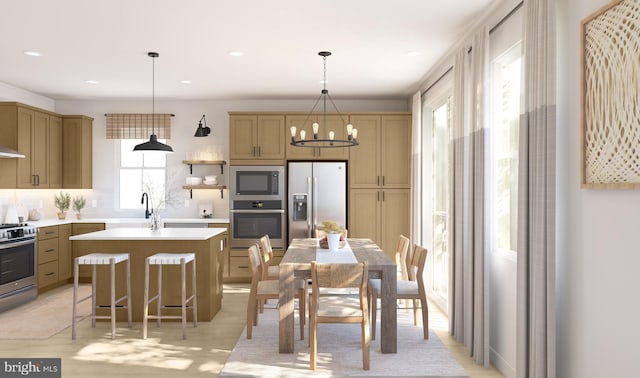 kitchen featuring appliances with stainless steel finishes, tasteful backsplash, pendant lighting, a center island with sink, and a chandelier