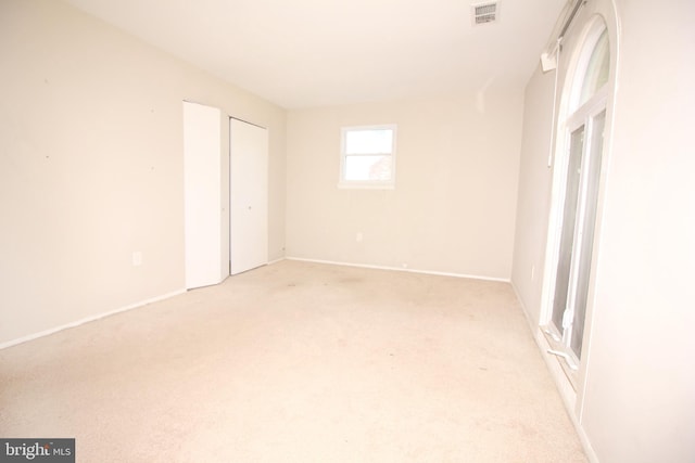 unfurnished bedroom with light carpet