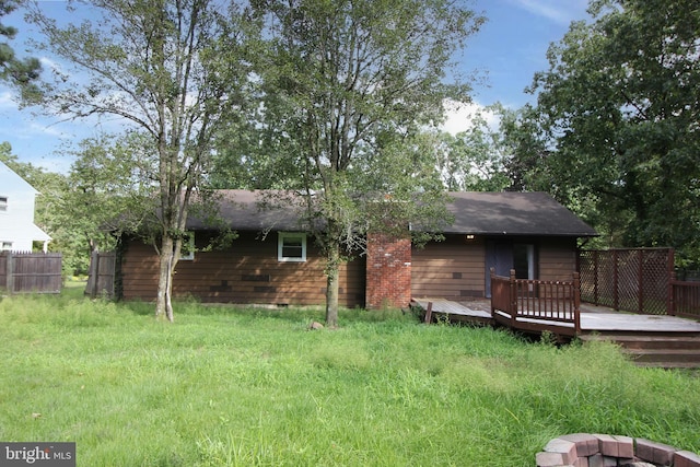 rear view of property featuring a wooden deck