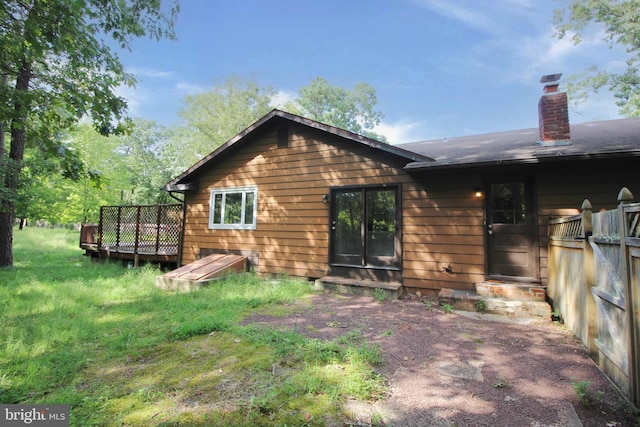 back of property with a wooden deck