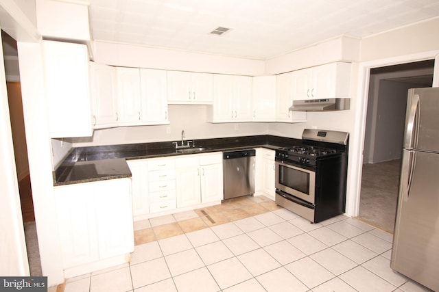 kitchen with white cabinetry, sink, light tile patterned flooring, and appliances with stainless steel finishes