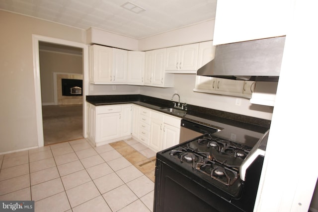 kitchen featuring sink, light tile patterned floors, stainless steel dishwasher, black gas stove, and white cabinets