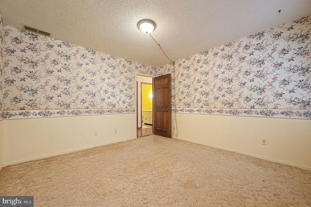 empty room featuring a textured ceiling