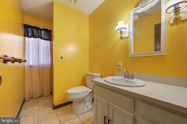 bathroom featuring a textured ceiling, tile patterned flooring, vanity, and toilet