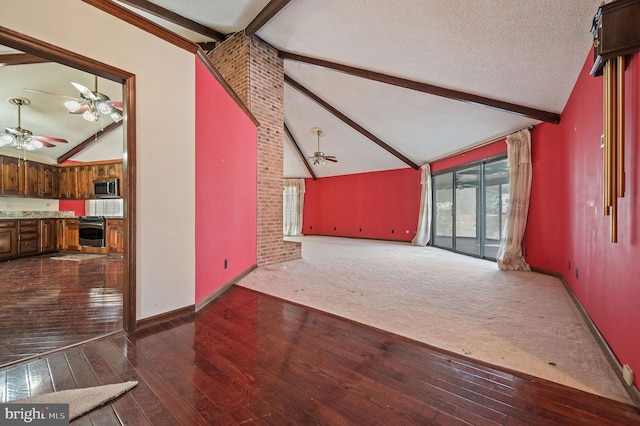 unfurnished living room with a textured ceiling, dark hardwood / wood-style floors, ceiling fan, and beam ceiling