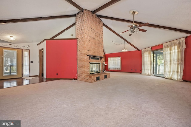 unfurnished living room with beam ceiling, high vaulted ceiling, ceiling fan with notable chandelier, and a fireplace