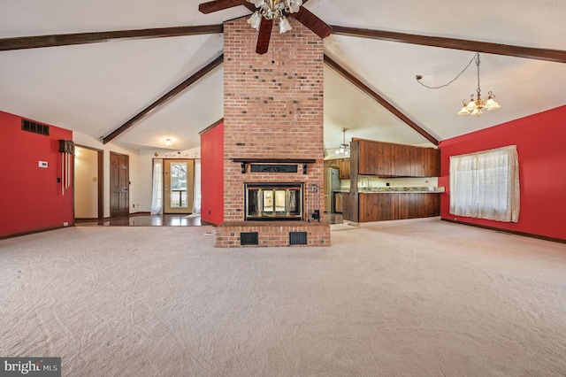 unfurnished living room featuring a brick fireplace, high vaulted ceiling, carpet, ceiling fan with notable chandelier, and beamed ceiling