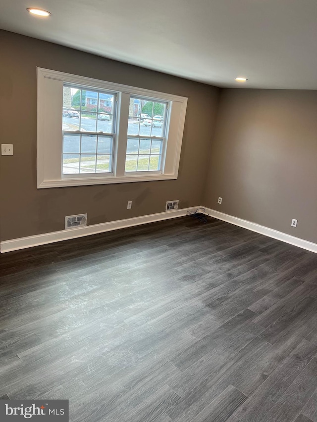 unfurnished room featuring dark hardwood / wood-style flooring